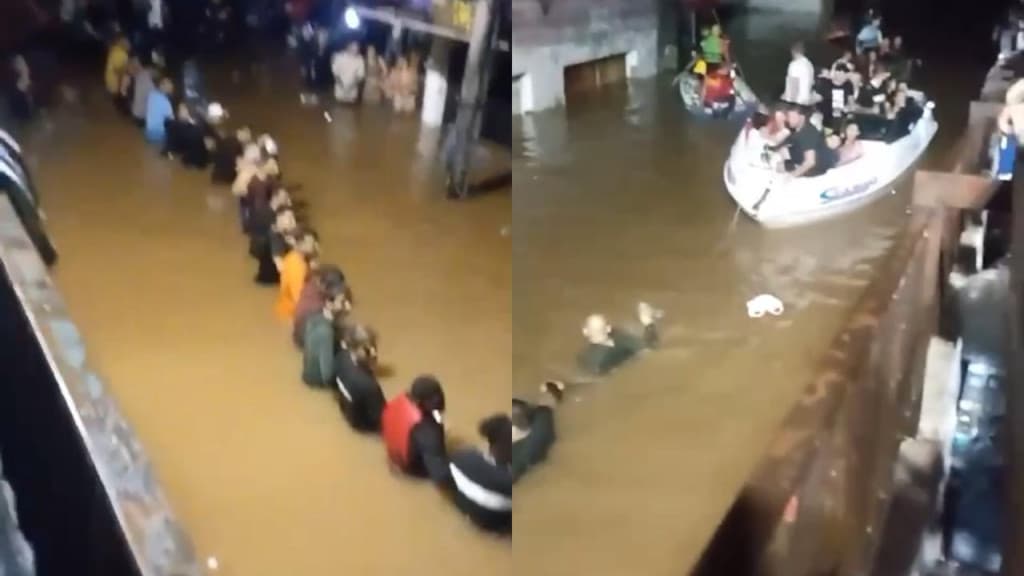Pessoas fazem “cordão humano” para puxar barco e salvar vítimas de enchente, em Canoas