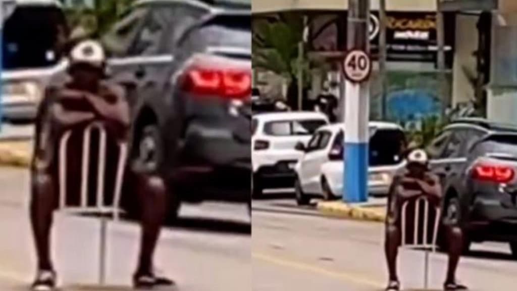 Cena inusitada: Homem senta em cadeira no meio de avenida em Itapema